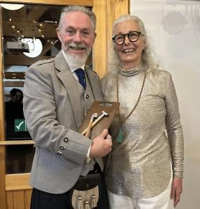 Rake Award Barry Collins Kick Ash Firewalks receiving the Prestigious Rake Award from Asa Beckman of Eight Directions, at the International Firewalk Gathering at Badaguish in 2025